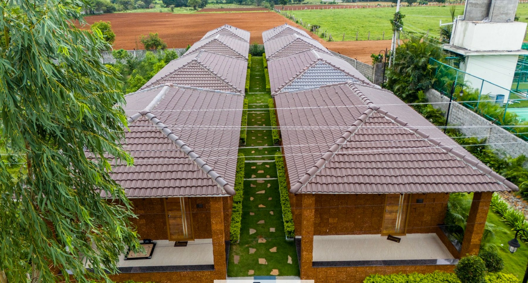 Top view of resort cottages and central green path