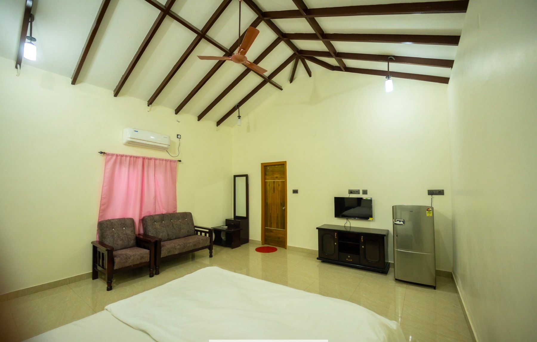 Family room with bed, seating, and amenities